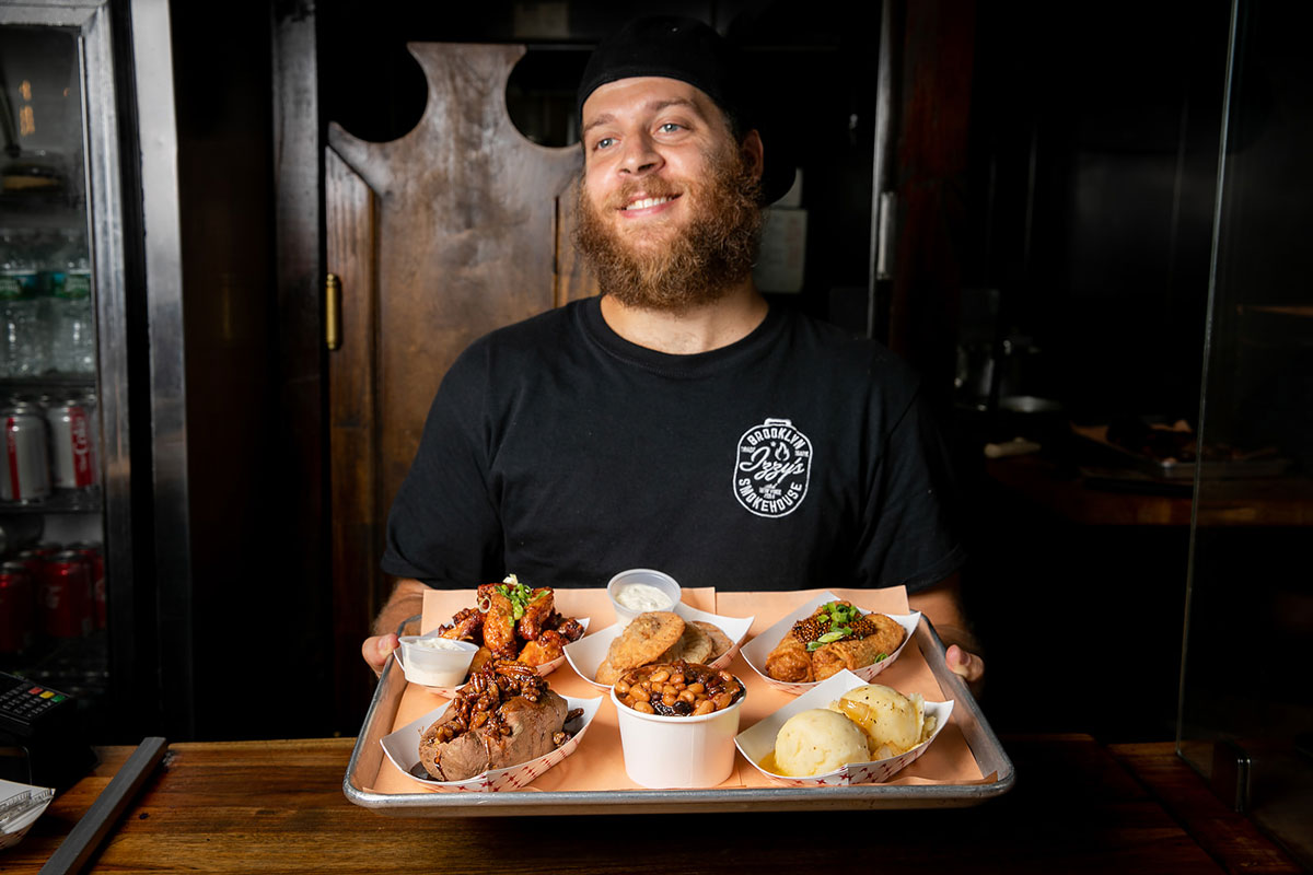 Izzy Smokehouse holding a food tray